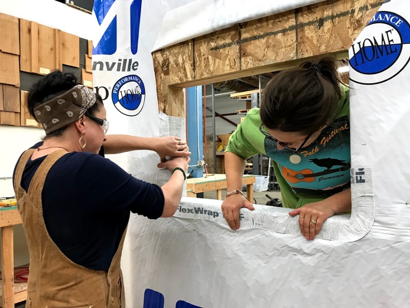 Two students installing a window