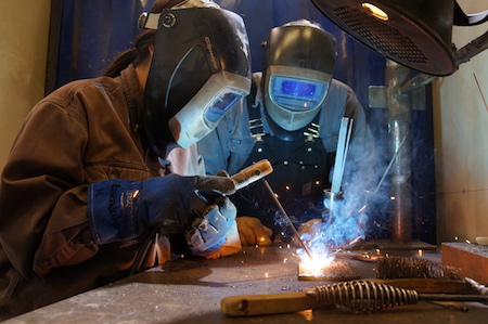 Two men working on an engine